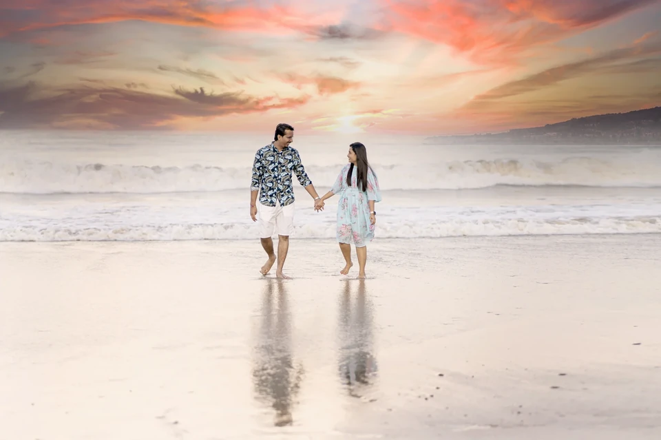 A couple walking together on a sunlit beach