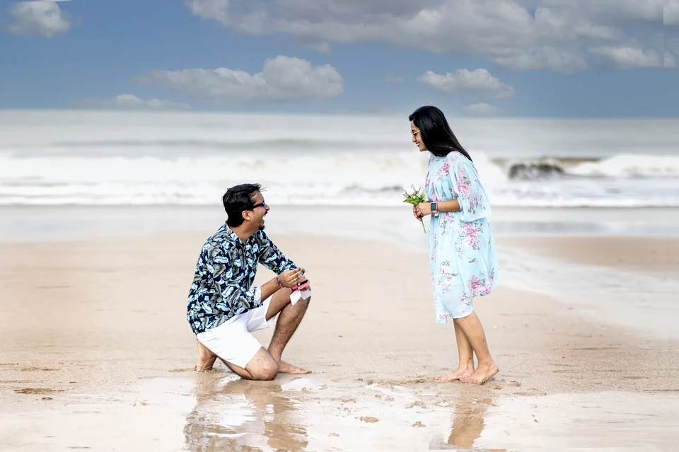 Playful beach proposal portrait