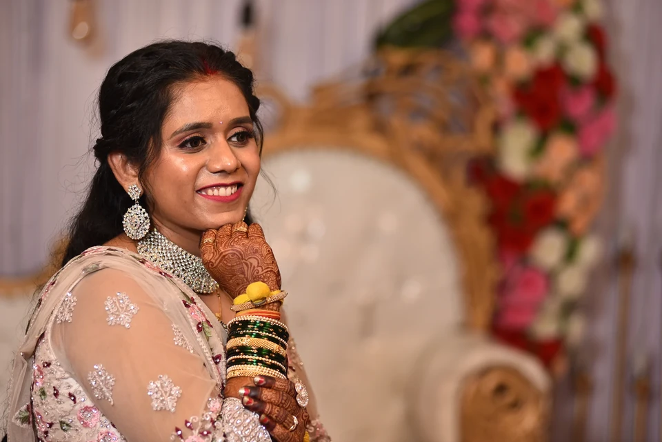 Smiling bride with henna and bridal jewellery